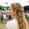 Woman showing completed braided half up boho hairstyle with loose waves and organic braid placement