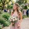 Bridesmaid with romantic half-up half-down hairstyle at outdoor wedding ceremony