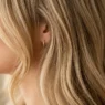 Woman with butter blonde balayage highlights showing seamless color transition from roots to ends