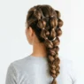 Completed rubber band hairstyle showing three twisted bubble ponytails from behind
