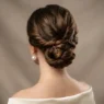 Close-up view of elegant chignon updo from behind showing strategic bobby pin placement and twisted sections at nape