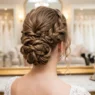 Elegant formal updo viewed from behind showing intricate twisted sections and bobby pin placement