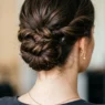 Elegant updo at nape of neck showing bobby pin placement and twisted curly sections