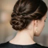 Close-up view from behind of elegant updo at nape showing precise bobby pin placement and twisted hair sections