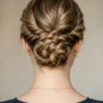 Close-up of elegant updo at nape showing bobby pin placement and twisted hair sections