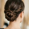 Elegant bridal updo at the nape with visible pin placement and twisted hair sections