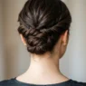 Back view of elegant updo showing precise bobby pin placement securing twisted hair sections at nape of neck