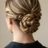 Elegant updo at nape of neck showing strategic bobby pin placement and twisted hair sections