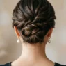 Elegant updo showing bobby pin placement and twisted hair sections with soft lighting