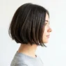 Woman with chin-length French bob hairstyle shown in side profile with natural lighting
