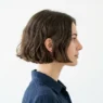 Woman with chin-length French bob showing natural texture and perfect cut in profile view