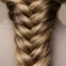 Close-up detail of intricate braid showing individual hair strands and crossover weaving technique