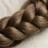 Close-up detail of intricate braid showing individual hair strands and crossover weaving technique