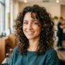 Woman with layered curly lob showing bouncy mid-length curls and face-framing layers