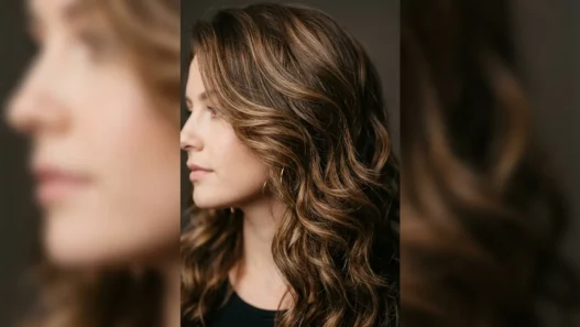 Woman with dimensional brown highlights in bouncy mid-length layered hair showing depth and movement