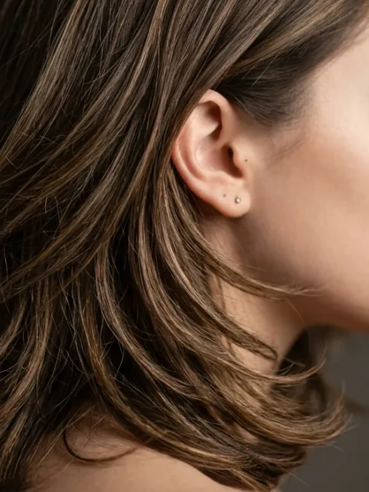 Woman with layered shoulder-length hair showing dimensional movement and strand separation in studio lighting