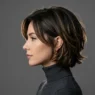 Woman with modern 90s layered bob hairstyle showing contemporary styling in professional studio lighting