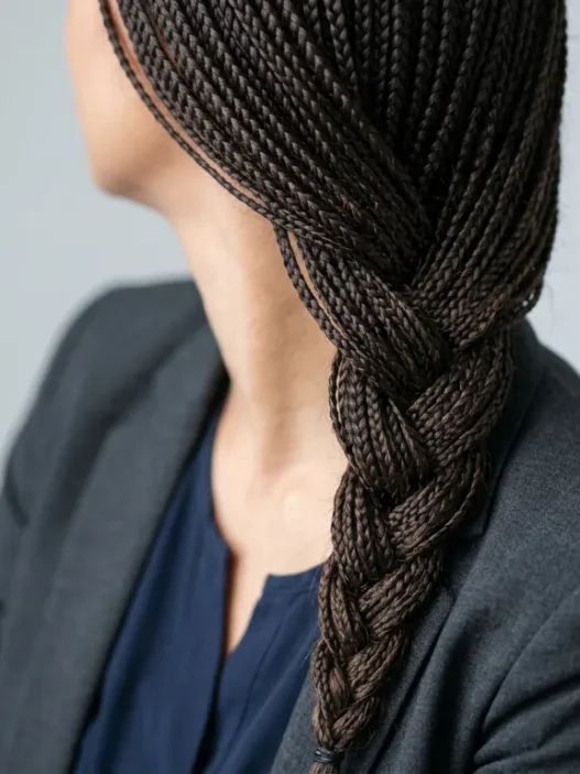 Woman with shoulder length French braid in professional portrait showing clean finished style