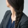 Woman with shoulder length French braid in professional portrait showing clean finished style