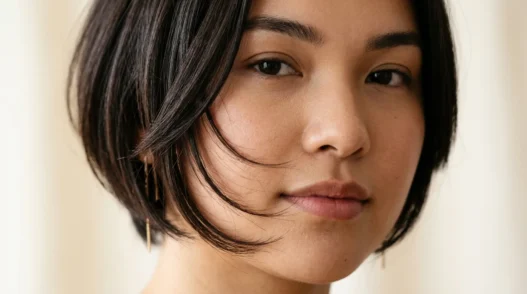 Woman with round face showing perfectly angled bob with forward-sloping face-framing layers that extend past jawline