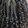 Close-up showing contrast between structured short braids and natural curl texture with dimensional movement