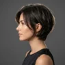 Woman with short layered haircut showing sophisticated bob styling in side profile view