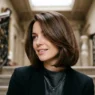 Woman with sophisticated bob haircut showing smooth texture and rich brunette color on grand staircase