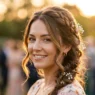Woman with elegant summer wedding guest hairstyle in golden hour sunlight