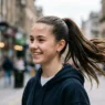 Teenage girl with sleek high ponytail showing volume at crown in natural daylight