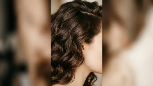 Close-up of thick chocolate brown wavy hair showing dense texture and natural wave pattern from jawline to crown