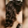 Close-up of thick chocolate brown wavy hair showing dense texture and natural wave pattern from jawline to crown