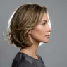 Woman with 90s layered bob showing chin-length layers and subtle movement in side profile