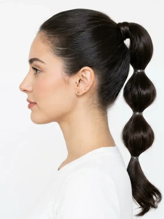 Woman showing completed bubble ponytail with multiple defined sections in side profile