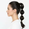 Woman showing completed bubble ponytail with multiple defined sections in side profile