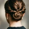 Woman showing elegant updo at nape with twisted sections and strategic pin placement