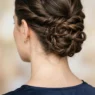 Close-up view from behind showing elegant updo with visible bobby pin placement and twisted hair sections