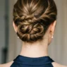 Close-up of elegant updo from behind showing bobby pin placement and twisted hair sections at nape