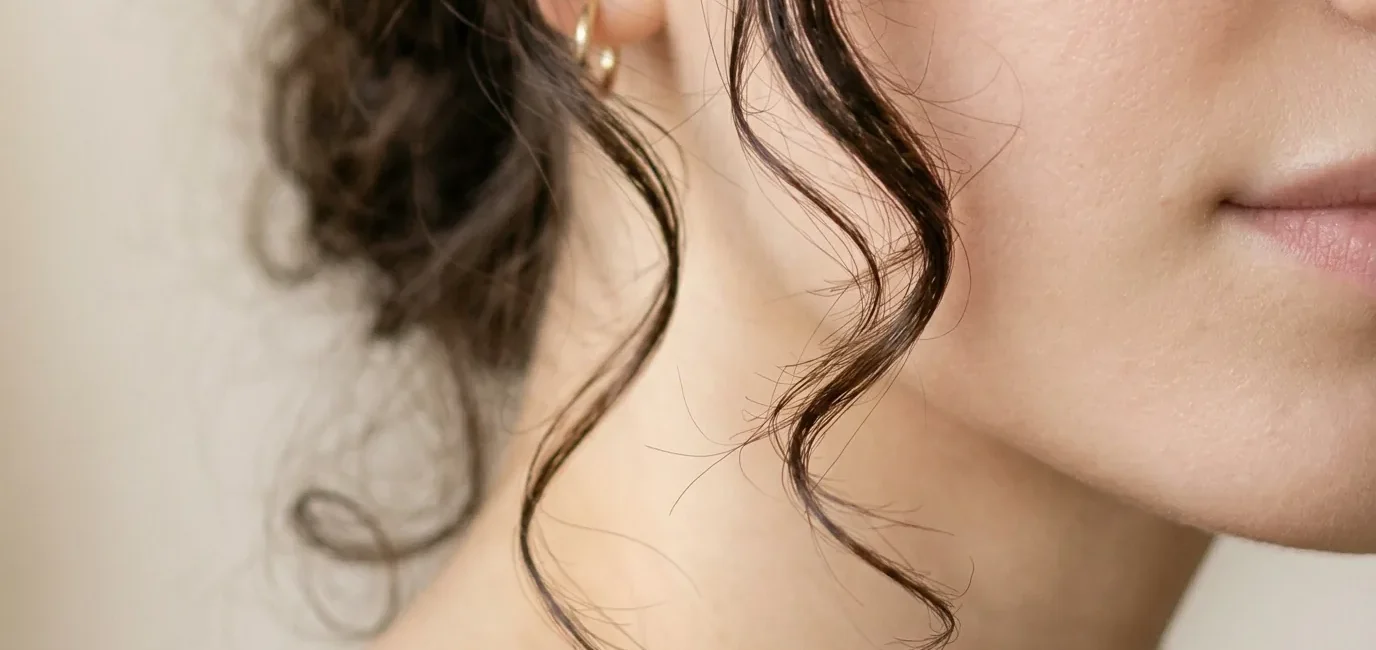 Woman with professionally cut face framing layers showing perfect placement around cheekbones and jawline