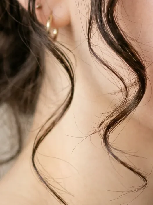 Woman with professionally cut face framing layers showing perfect placement around cheekbones and jawline