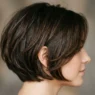 Woman with graduated short bob showing smooth layer transitions from crown to jawline
