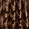 Close-up of perfectly defined spiral wave patterns in long brunette hair showing natural curl formation