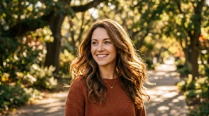 Woman with natural textured ponytail in golden morning sunlight showing hair movement