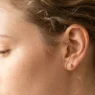 Close-up of delicate wispy hair tendrils and baby hairs at woman's temple area with soft lighting
