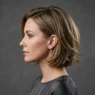 Woman with classic 90s layered bob showing feathered ends and jaw-length layers in elegant side profile studio shot