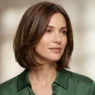 Woman with chin-length layered bob with soft under-bend and glossy dimension in studio light