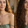 Woman with very long dark brown curls past chest in golden side lighting